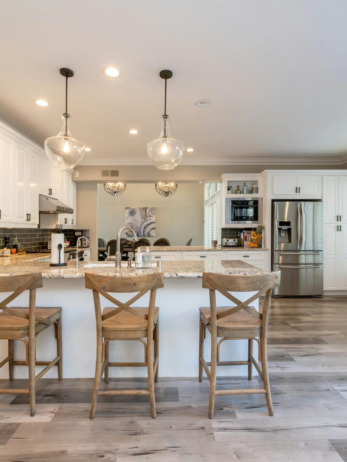 Bright and spacious kitchen interior featuring bar stools and modern design elements.